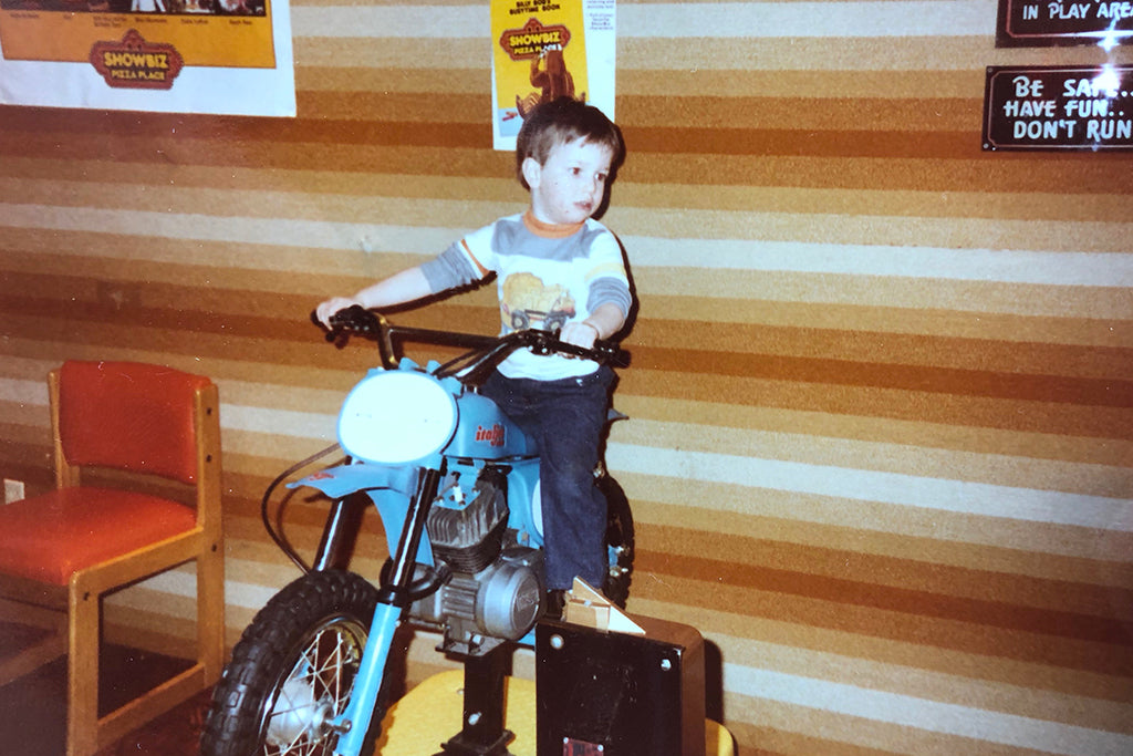 Sam Stewart as a kid on a motorcycle